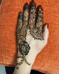 a woman's hand is decorated with hennap and flower designs on it