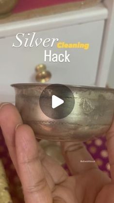 a person holding a silver colored metal bowl in their hand with the words silver cleaning hack on it