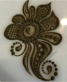 a henna design on a white plate