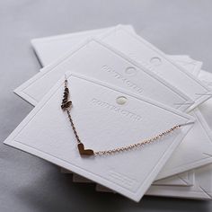 Custom Pure White Necklace Display Cards, Personalized Jewelry Cards, 6x8cm White Bracelet Packaging Cards MOQ= 500 pcs, Size: 6x8cm / 2.4x3.1 ★ ★ ★ Item: Earring Cards Material: 500GSM White Paper Card Size: 6x8cm / 2.4x3.1 Card Color: Pure White It is for Necklaces, bracelets, anklets. 2 Slots on the top of the cards. No earring slots. Kind note: Jewelry Cards ONLY! Jewelry in photos is not included. We Custom logo for 500 pcs. Custom Logo/text Hot-Pressed Sunken Colorless on one side. Price i Minimalist Rectangular Jewelry For Valentine's Day, Minimalist Rectangular Valentine's Day Jewelry, Elegant Mother's Day Jewelry With Message Card, Elegant Valentine's Day Necklace With Message Card, Gold Jewelry With Message Card For Mother's Day, Necklace Display Cards, Packaging Cards, Bracelet Packaging, Jewelry Cards