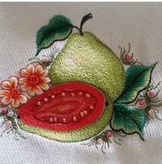 an embroidered piece of fruit with flowers on it