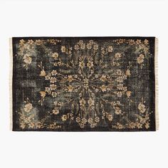 an antique rug with flowers and leaves on the side, in dark green tones against a white background