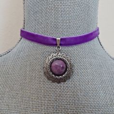 A lovely violet purple velvet ribbon is accented with a sliding pinch bail linked to an antique silver circular pendant with a set purple stone bead cabochon.  The ribbon is crimped with silver crimp bars with a matching chain for adjustable sizing from 13 " - 15". There is a wire wrapped violet crystal bead dangle linked on the chain.  The ribbon is 3/8" wide and there is a matching silver hook closure on the choker.  All of my jewelry items come boxed, and ribbon tied and tagged for easy gifting. Vintage Adjustable Purple Jewelry, Adjustable Vintage Purple Jewelry, Vintage Purple Round Pendant Jewelry, Adjustable Purple Pendant Jewelry, Adjustable Lavender Round Jewelry, Adjustable Round Lavender Jewelry, Adjustable Lavender Jewelry, Purple Cabochon Round Pendant Jewelry, Victorian Purple