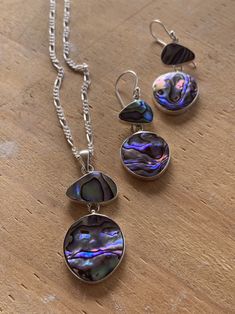 Modern design abalone earrings and necklace set, abalone set in sterling silver on 16 inch sterling silver chain. Made in Bali. A gorgeous set! The pendant hangs 1.5 inches and is 3/4 inch at its widest. The earrings hang 1.25 inches and are 5/8 inch wide at their widest. Price is for the set but if you want only the necklace or the earrings, message me. These would make a lovely engagement gift, graduation gift, birthday gift or something just special for yourself. Iridescent Sterling Silver Round Jewelry, Iridescent Round Sterling Silver Jewelry, Polished Mother Of Pearl Pendant Jewelry, Elegant Silver Abalone Shell Jewelry, Silver Pearl Pendant Jewelry In Mother Of Pearl, Silver Mother Of Pearl Jewelry With Round Shape, Silver Mother Of Pearl Round Jewelry, Silver Round Mother Of Pearl Jewelry, Silver Mother Of Pearl Jewelry For Gift