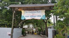 the undersea park sign is hanging over an entrance