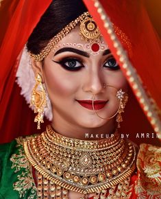 a woman with makeup and jewelry on her face