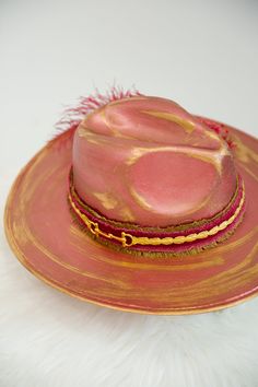 Feel like a modern-day cowboy with THE VERONA RANCHER HAT! Featuring a cool mauve base with Golden accents, this stylish hat is the perfect way to add some standout style to your wardrobe. With a chic red and gold band and a fun red and gold feather combo, you can look great for any occasion! This hat is ONE OF A KIND, created by our owner Stephanie. To receive item quicker, expedited shipping is available at checkout. Rancher Hat, Gold Feathers, Stylish Hats, Red And Gold, Gold Band, Verona, Gold Bands, Feel Like, Looks Great