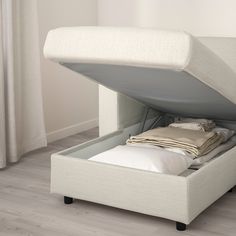 a bed with an open storage compartment underneath it