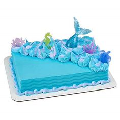 there is a cake with blue frosting and sea animals on it