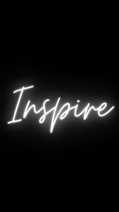 the words inspire are lit up against a black background