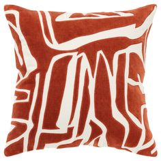 an orange and white pillow on a white background