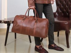 Sleek and stylish Leather Duffle Bag, premium full grain Leather Bag handcrafted to masterpiece.  Unisex appeal that compliments both men and women. Perfect for short weekend trips, effortlessly accompanied as a daily carry-on gym bag. Features: - Floor-To-Floor Zip Allows Convenient Packing - Carry-On Size - Internal Zip Pockets And Open Pockets - Double-Stitched Seams for Durability - Reinforced Leather Handles - Two Way Metal YKK Zippers - Protective Metal Feet on The Bottom Panel of Bag - Du Business Soft Leather Rectangular Duffle Bag, Brown Business Travel Bag With Smooth Grain, Brown Business Duffle Bag, Formal Soft Leather Rectangular Duffle Bag, Formal Rectangular Weekender Bag With Smooth Grain, Formal Rectangular Soft Leather Duffle Bag, Brown Smooth Grain Travel Bag For Business, Formal Brown Travel Bag With Smooth Grain, Business Rectangular Weekender Bag With Leather Backing