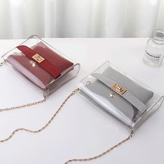 This chic bag features a unique transparent outer-shell with complimenting leather interior detail and a chain strap. Comes in five color designs from which to choose. Chic Bags, Chloe Drew, Leather Interior, Interior Details, Chain Strap, Color Design, Shells, Chain, Red