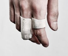 a man's hand with a band around it and his fingers wrapped in bandages