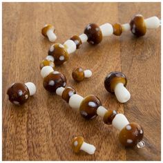 some brown and white candy sticks on a wooden table with the word love spelled out