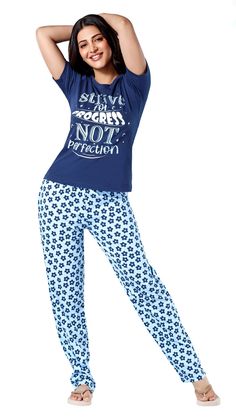 a woman is posing in pajamas with her arms behind her head