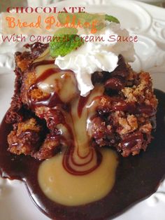 chocolate bread pudding with caramel cream sauce and whipped cream on top, sitting on a white plate