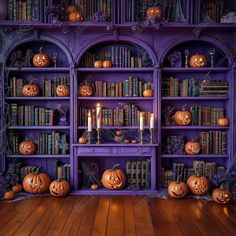 there are many pumpkins on the bookshelves and candles in front of them