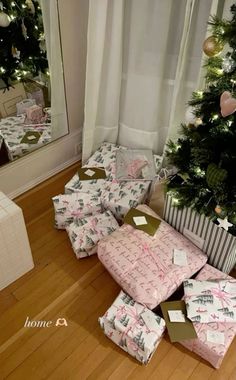 presents under the christmas tree are wrapped in pink and green paper