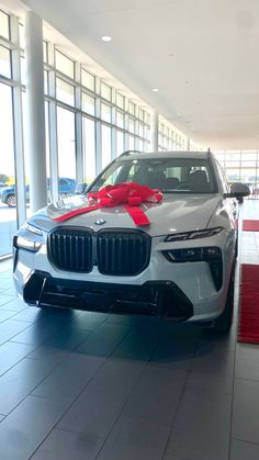 a white car with a red bow on it