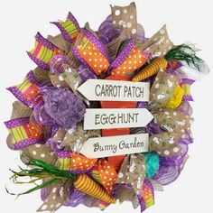 an egg hunt wreath with carrots, flowers and arrows that say carrot patch, egg hunt, bunny garden