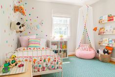 a child's bedroom decorated in pastel colors