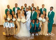 a bride and groom posing with their wedding party