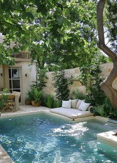 an outdoor pool surrounded by trees and plants