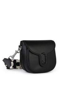 Made of smooth leather, removable shoulder strap with fabric logo with leather inserts, magnetic flap closure with tonal logo, large main compartment, one inner pocket, one inside zip pocket \n21 x 16 x 7 cmMARC JACOBS (THE)'SADDLE' BLACK LEATHER BAG Top Handle Saddle Bag With Branded Hardware For Travel, Leather Saddle Bag With Flap For Evening, Leather Top Handle Bag With Logo Strap, Saddle Shoulder Bag With Branded Hardware For Travel, Travel Saddle Shoulder Bag With Branded Hardware, Satchel Saddle Bag With Branded Hardware For Travel, Luxury Satchel Bag With Logo Strap, Designer Leather Bag With Logo Strap, Leather Shoulder Bag With Removable Pouch And Flap