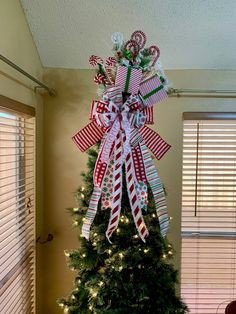 a christmas tree decorated with candy canes and bows