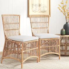 two wicker chairs sitting next to each other on top of a carpeted floor