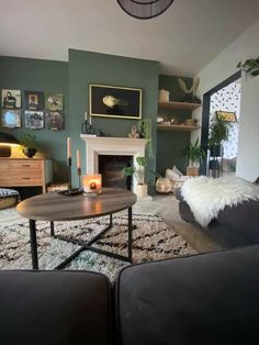 a living room filled with furniture and a fire place in the middle of the room