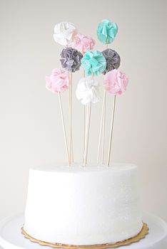 a white cake topped with lots of colorful flowers