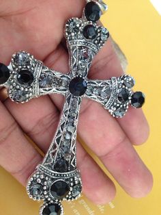 "Beautiful antique silver finished cross necklace with black and silver rhinestone , a true fashion statement all hand finished with rhinestones of all sizes from 3mm to 9mm, the Cross measures 4.5\" inches long and almost 3\" wide. The chain is also pewter with oxidized silver finish measures 23\" inches Perfect for a gift!! Hermoso Crucifijo con brillantes terminado en un Tono plata Antigua, la Cruz mide 4.5\" pulgadas de largo y casi 3\" pulgadas de ancho. La cadena mide 23\" pulgadas de larg Crystal Rhinestone Cross Necklace For Gift, Silver Rhinestone Crucifix Jewelry, Cross-shaped Rhinestone Jewelry For Parties, Elegant Cross-shaped Rhinestone Necklace For Parties, Cross-shaped Rhinestone Necklace With Bling For Gifts, Wedding Lasso, Rear View Mirror Decor, Baptism Candle, Crystal Angels