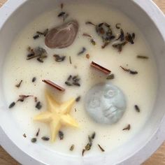 a white bowl filled with liquid and star shaped items