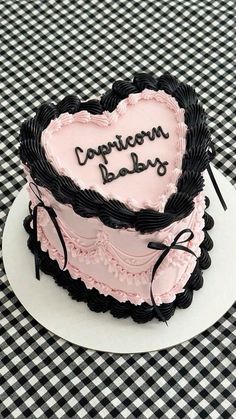 a heart - shaped cake with the words congratulations baby written on it is sitting on a table