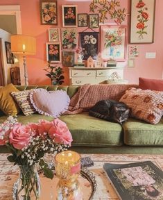 a living room filled with furniture and pictures on the wall