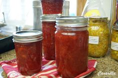 jars filled with pickled vegetables sit on a kitchen counter