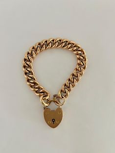 Antique Victorian Gold Heart Lock Curbchain Bracelet - 15k. During the Victorian Era, the heart lock bracelet was a symbol of love and fidelity. The heart lock is simple and classic, made of solid 15k gold. MARKINGS AND HISTORY: Marked 15k gold, with British hallmarks as shown in photo. (Please reach out if more information is needed!) ERA: Circa 1880's OVERALL CONDITION: This beautiful bracelet is in excellent condition overall, all links are in great condition and the heart lock is functioning perfectly. The bracelet also has a safety chain, adding extra security. There are some small surface scratches on the lock. Classic Formal Bracelet With Heart Charm, Classic Gold Lock Jewelry, Classic Bracelets With Heart Charm, Classic Gold Jewelry With Lock Detail, Classic Gold Heart Bracelet With Charm, Lock Sketch, Bracelet Lock, Lock Bracelet, Heart Lock