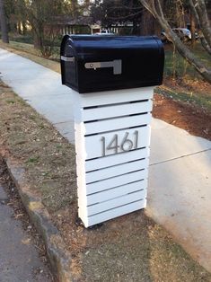 a mailbox with the number forty four on it is sitting next to a sidewalk