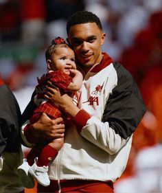 a man holding a small child in his arms