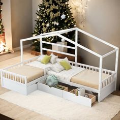 a dollhouse bed with drawers underneath it and a christmas tree in the corner behind it