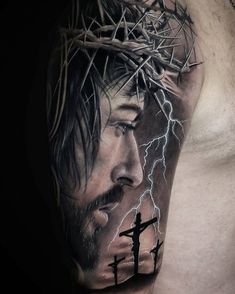 a man's chest with a jesus tattoo on it and lightning coming from his head