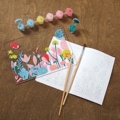 some crafting supplies are laying out on a table with markers and pencils next to them