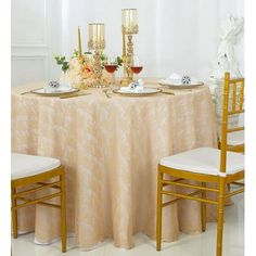 the table is set with two gold chairs