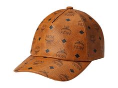 MCM MCM Collection Cap - Caps : Cognac : Get compliments for your elite choice in accessories wearing the MCM Collection Cap. Made of cotton and polyester blend material with PU coating. Allover iconic branded print. Curved brim. Adjustable buckle strap back closure. Viscose lining. Spot clean. Imported. Measurements: Brim: 2 3 5 in Designer Visor Hats For Travel, Designer Brown Hat For Travel, Designer Adjustable Hats For Travel, Designer Baseball Cap With Short Brim, Designer Adjustable Baseball Cap With Short Brim, Designer Baseball Cap With Adjustable Short Brim, Luxury Travel Visor Hat, Designer Flat Brim Travel Hat, Luxury Brown Travel Hat