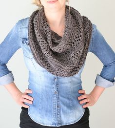 a woman standing with her hands on her hips wearing a crocheted cowl