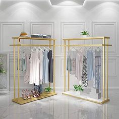 an open closet with clothes and shoes on display in front of a wall mounted mirror