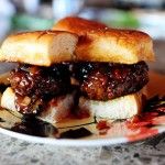 a meatball sandwich sitting on top of a white plate