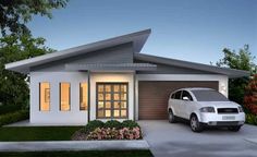 a white car is parked in front of a house with two windows and a garage